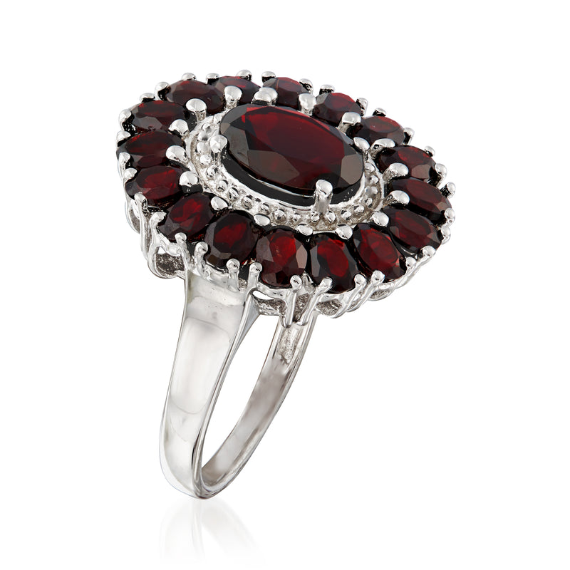 Sterling silver garnet ring side view with oval center stone and red halo