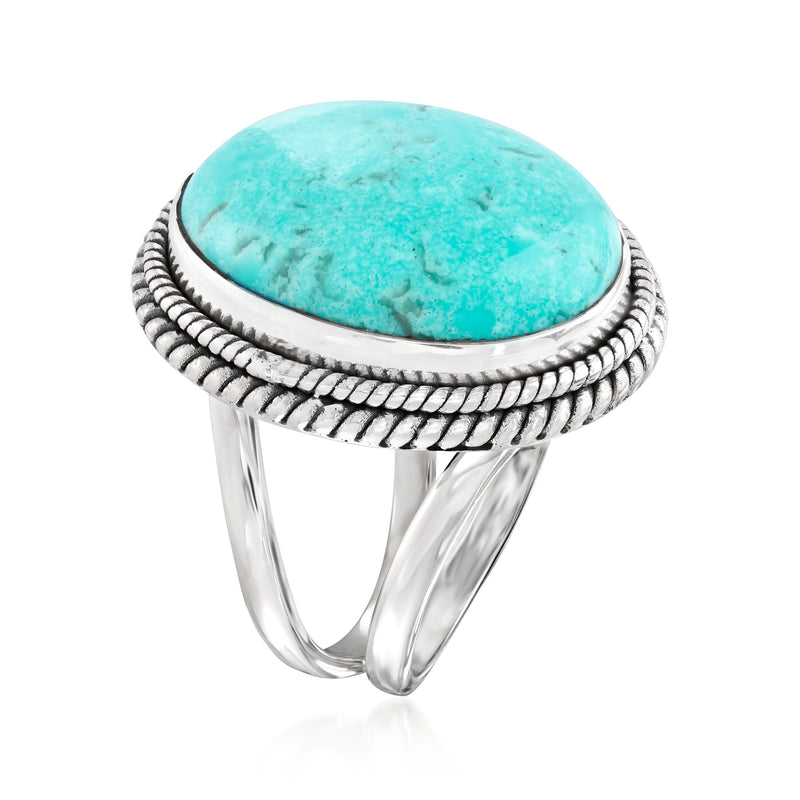 Sterling silver ring with turquoise oval cabochon, rope-textured border, side view