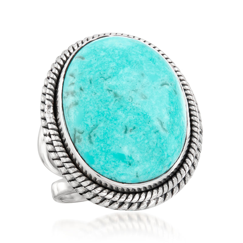 Sterling silver turquoise oval cabochon ring with braided frame, angled view