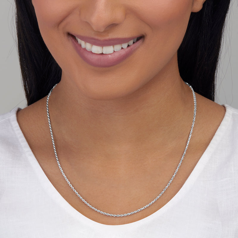 Sterling silver rope-chain necklace on model, thin linked chain drape