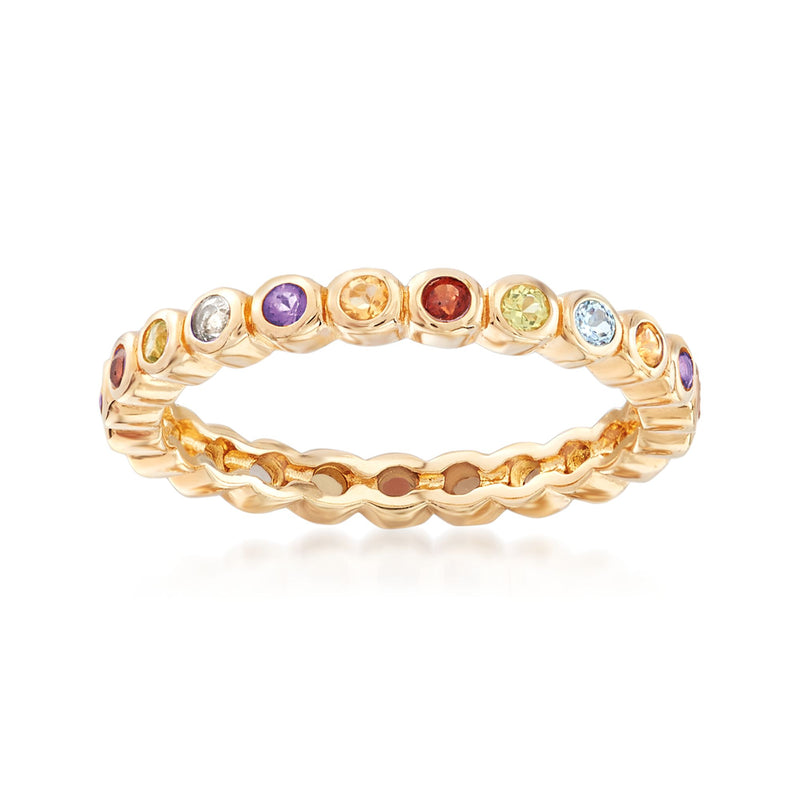 Gold eternity band ring with multicolor gemstones in round bezel settings.