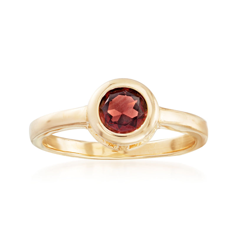 Bezel-set garnet ring with round dark red stone in gold-tone band