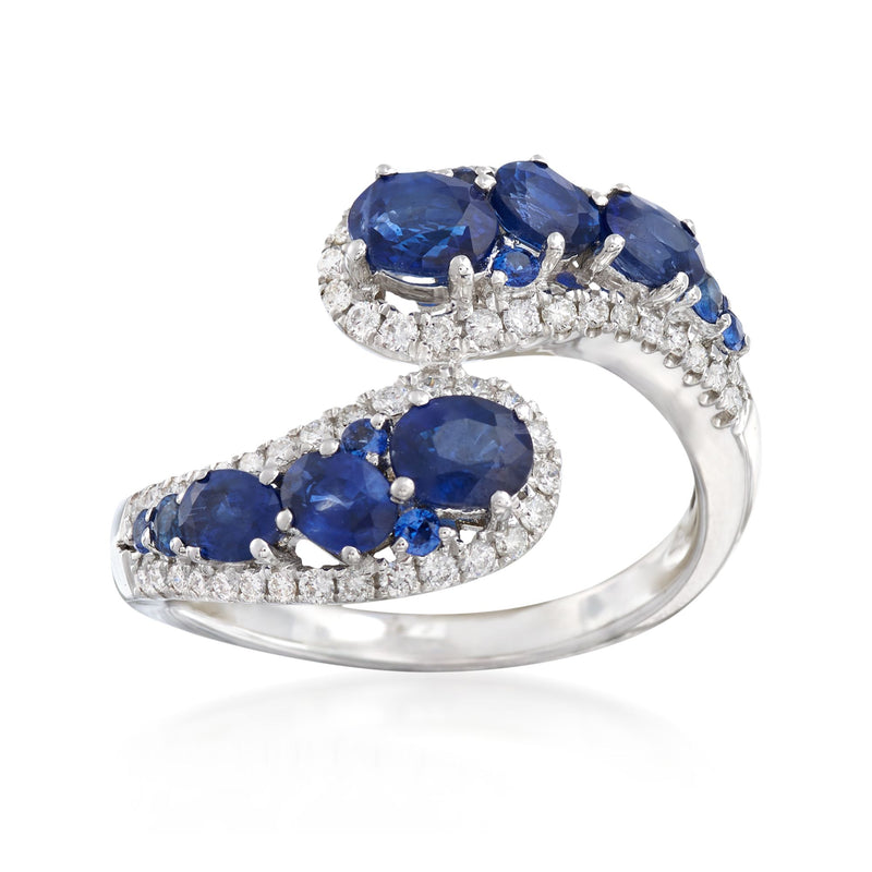 18kt white gold bypass ring with oval blue sapphires and diamond accents