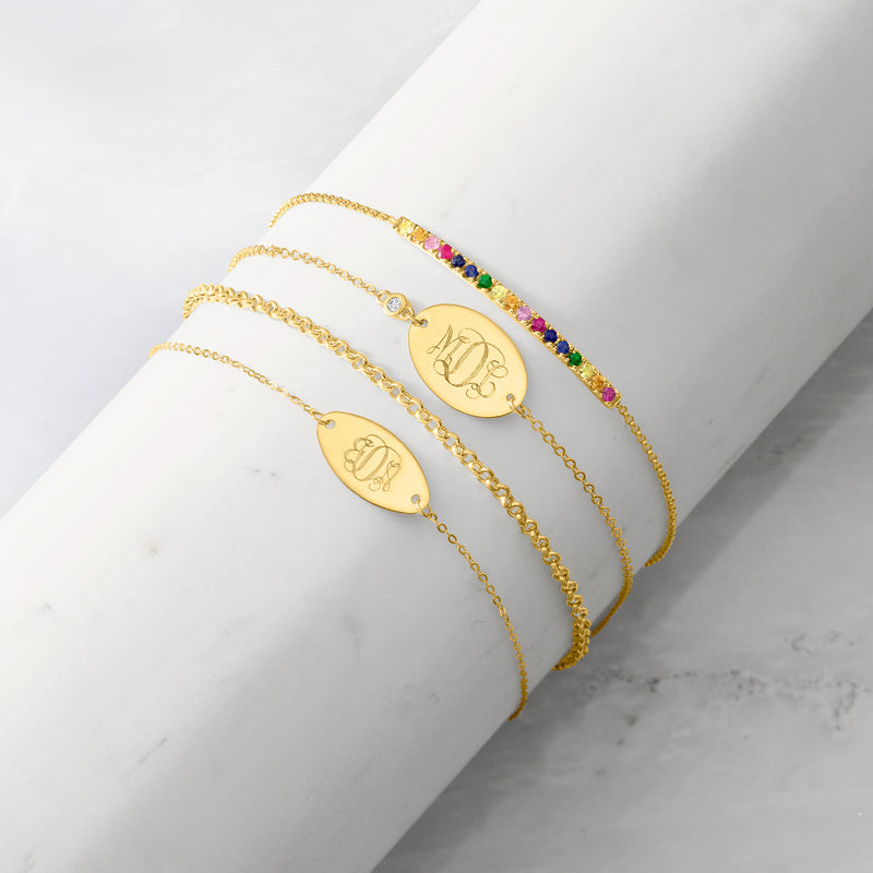 14kt yellow gold oval disc bracelet with engraved initials on slim chain