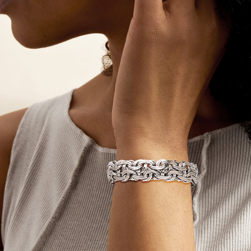 Sterling silver Byzantine chain bracelet on wrist with braided textured links