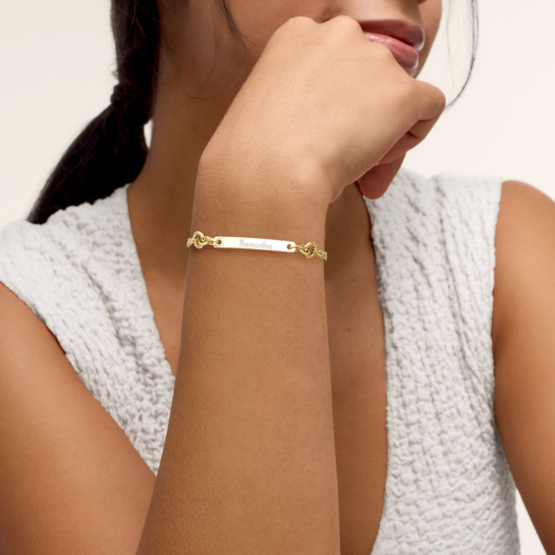 14kt yellow gold personalized ID bracelet worn on wrist with engraved name bar