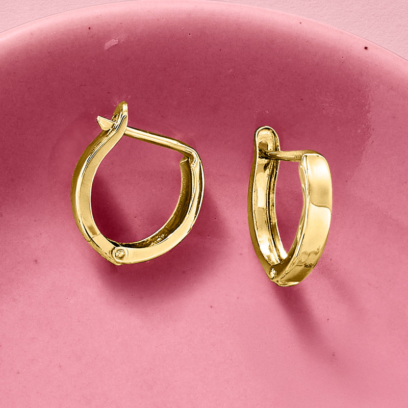14kt yellow gold huggie hoop earrings with hinged clasp, oval hoop silhouette.