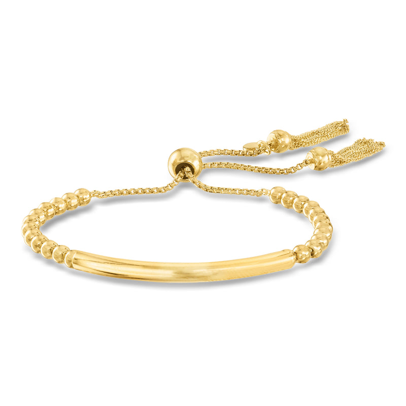 Gold bead bolo bracelet with smooth bar and chain tassel ends