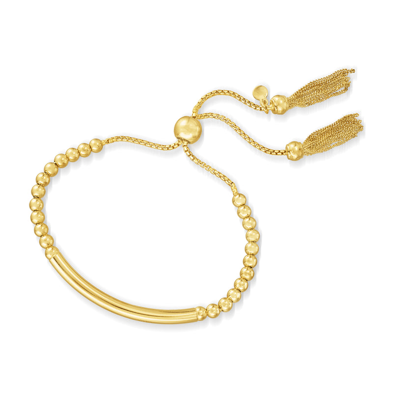 Gold bead bolo bracelet with tassel ends and curved bar centerpiece