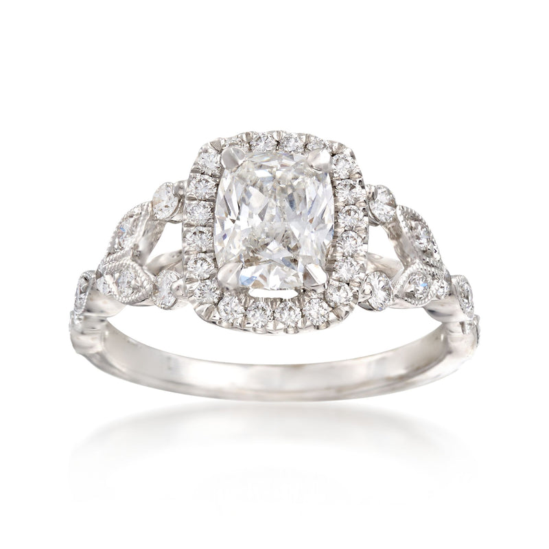 18kt white gold engagement ring with cushion-cut diamond center, halo, and side stones
