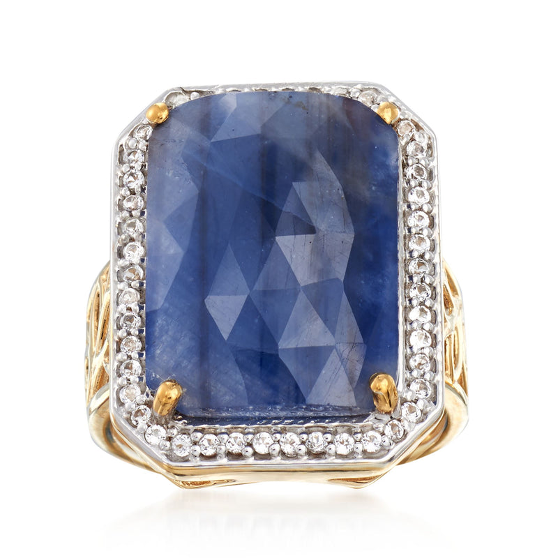 Two-tone gold ring with large blue cushion-cut sapphire and diamond-like halo stones