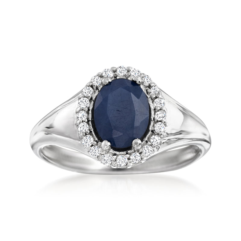 Sterling silver ring with oval dark blue sapphire and white gemstone halo