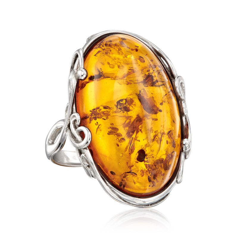 Orange amber oval ring in sterling silver with scalloped bezel and side loops