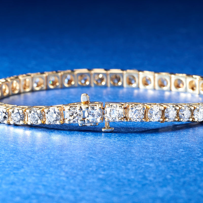 14kt yellow gold tennis bracelet close-up of round diamond row and hinged clasp