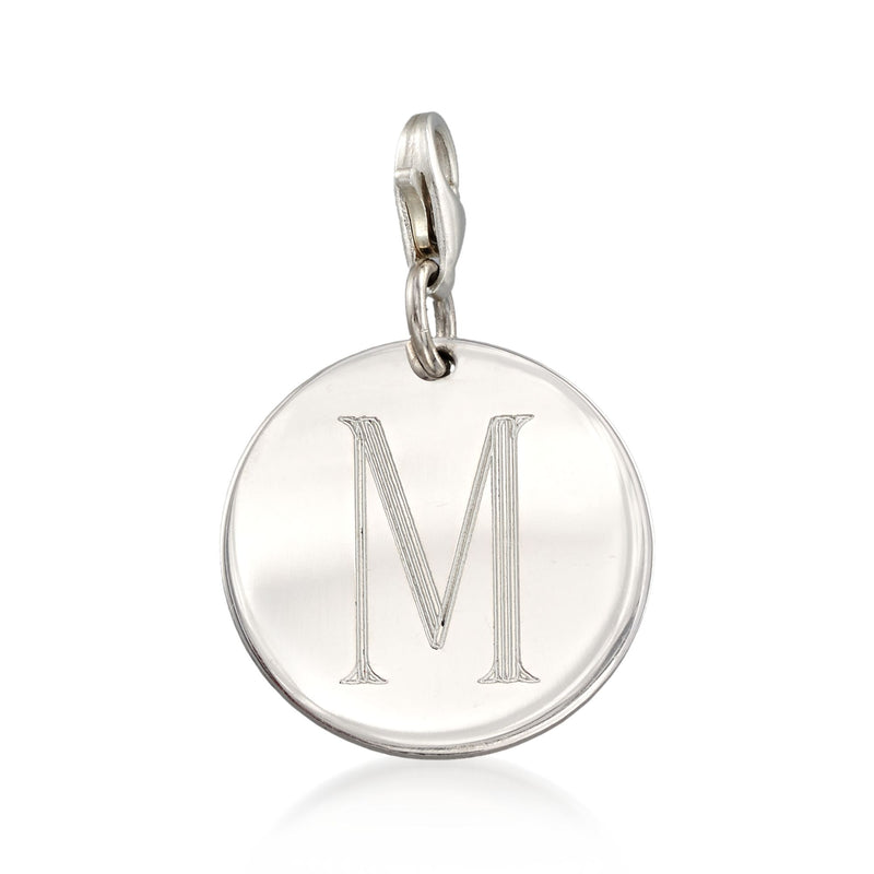 Round sterling silver disc charm with raised letter M, attached to a bail