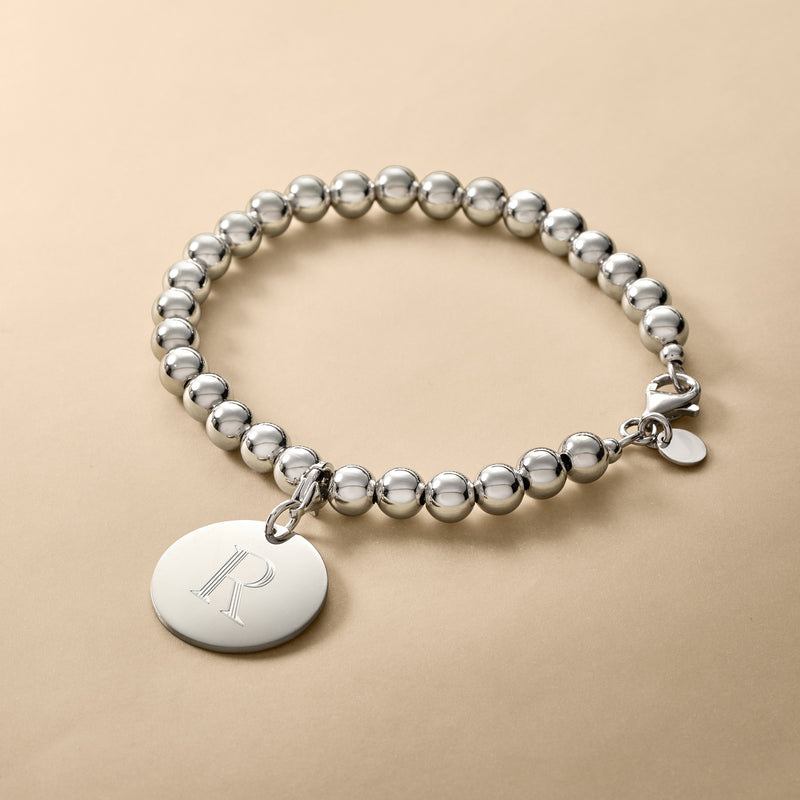 Sterling silver bead bracelet with round disc charm and small heart clasp