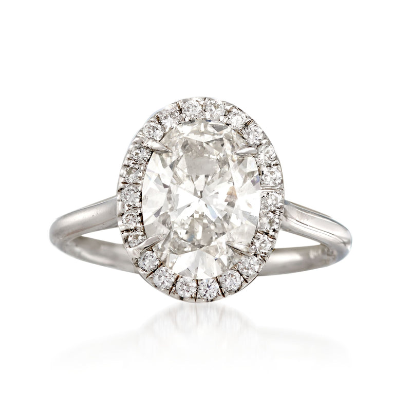 Oval diamond ring in 18kt white gold with halo setting