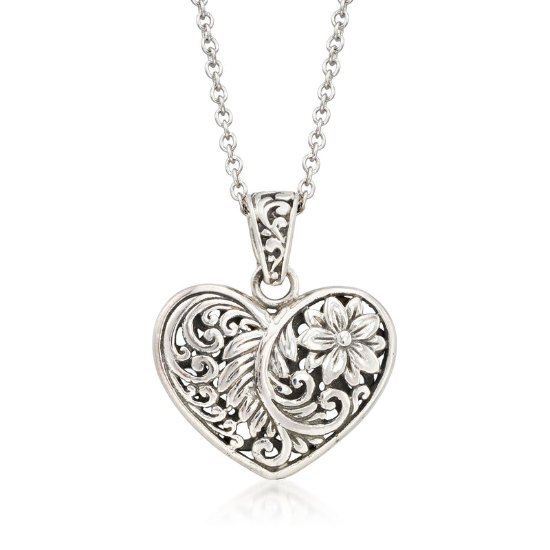 Sterling silver heart pendant necklace with carved filigree and raised flower detail