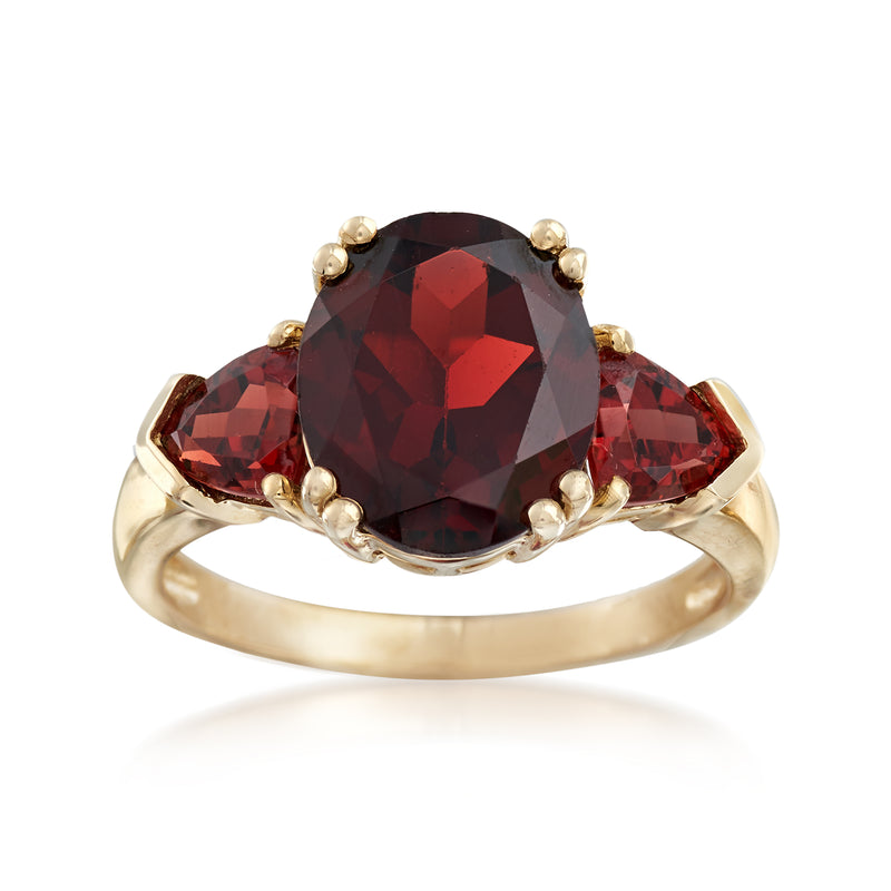 14kt yellow gold garnet ring with oval dark red center stone and marquise side stones