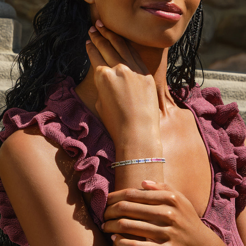 Multicolor sapphire and diamond tennis bracelet in 14kt yellow gold, close-up on wrist