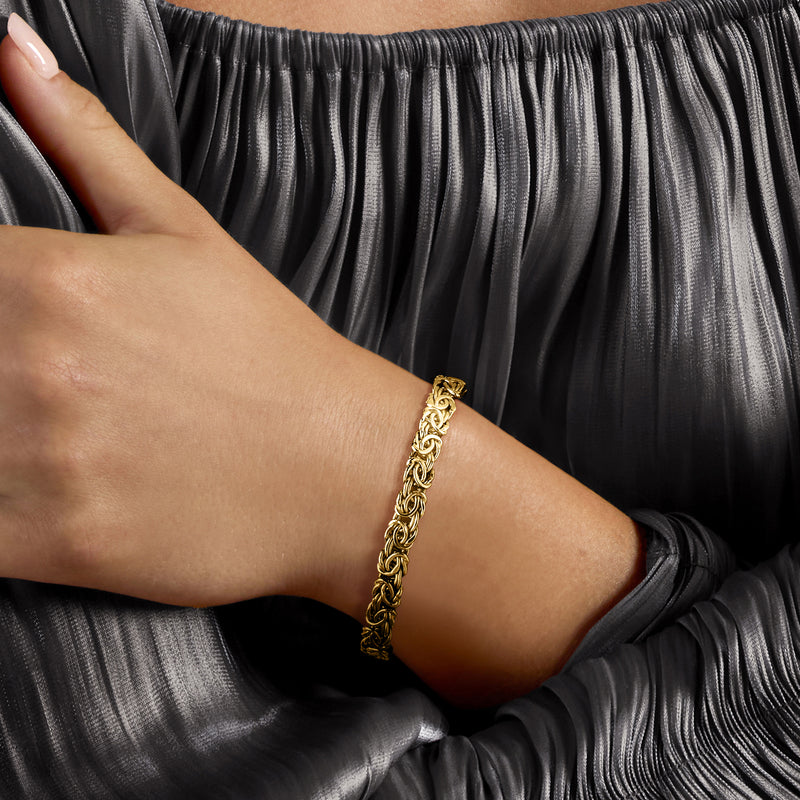 Gold over sterling silver Byzantine bolo bracelet worn on wrist with twisted links