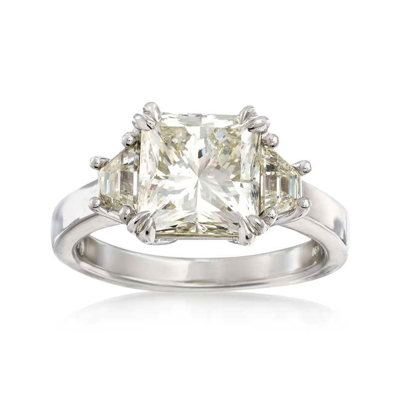 18kt white gold ring with emerald-cut diamond center and side stones