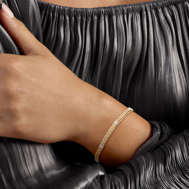 14kt yellow gold wheat-chain bracelet on wrist with small diamond accents