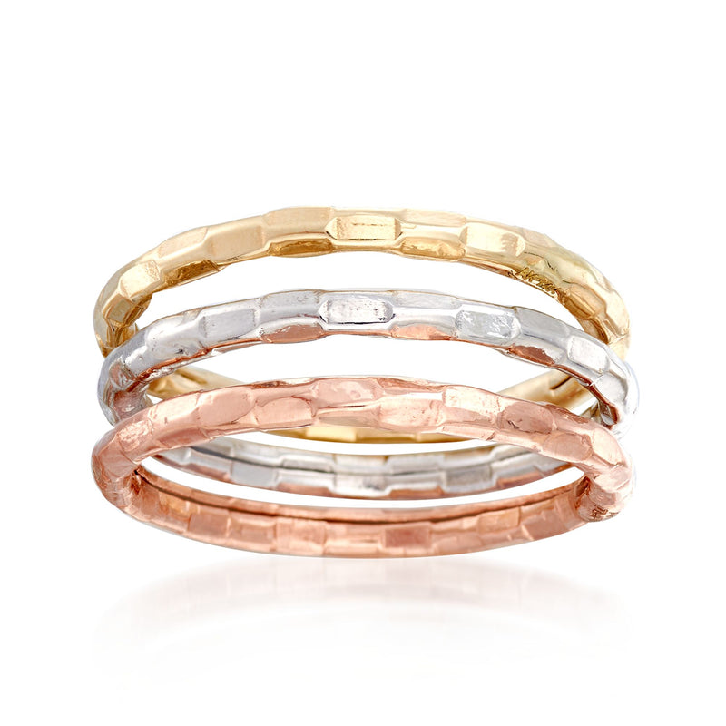 Three stackable 14kt gold bands in yellow, white, and rose with polished finish