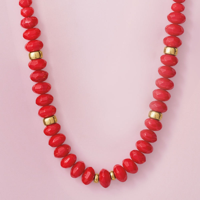 Close-up of graduated red coral beads with 14kt yellow gold barrel spacers