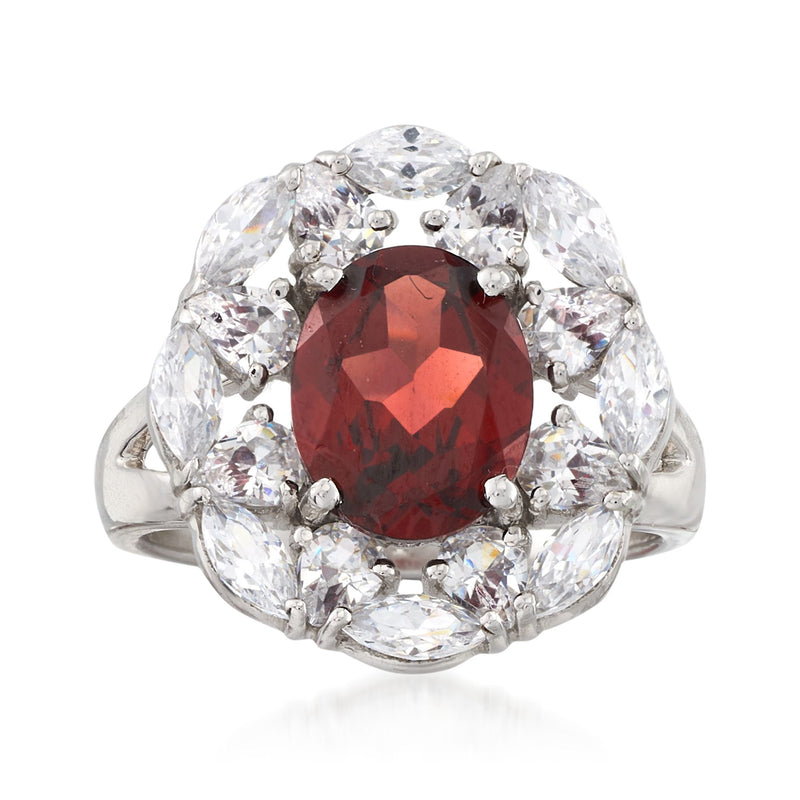 Sterling silver ring with oval red garnet center and clear white topaz halo