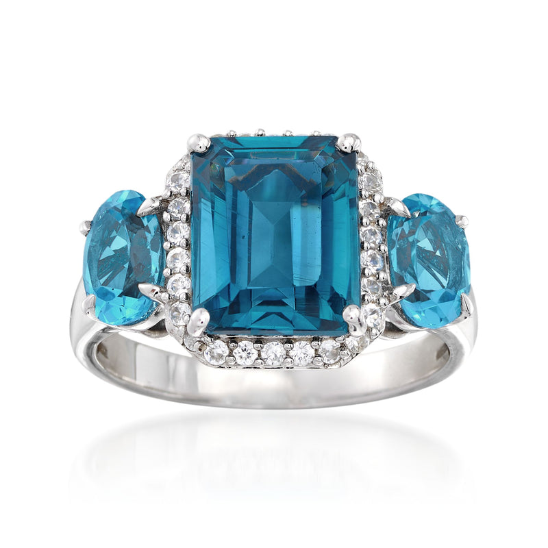 Sterling silver ring with large blue topaz center and blue side stones, with white zircon accents.