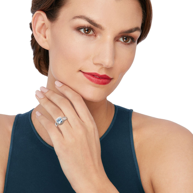 Sky-blue topaz two-tone sterling silver Bali-style ring on finger