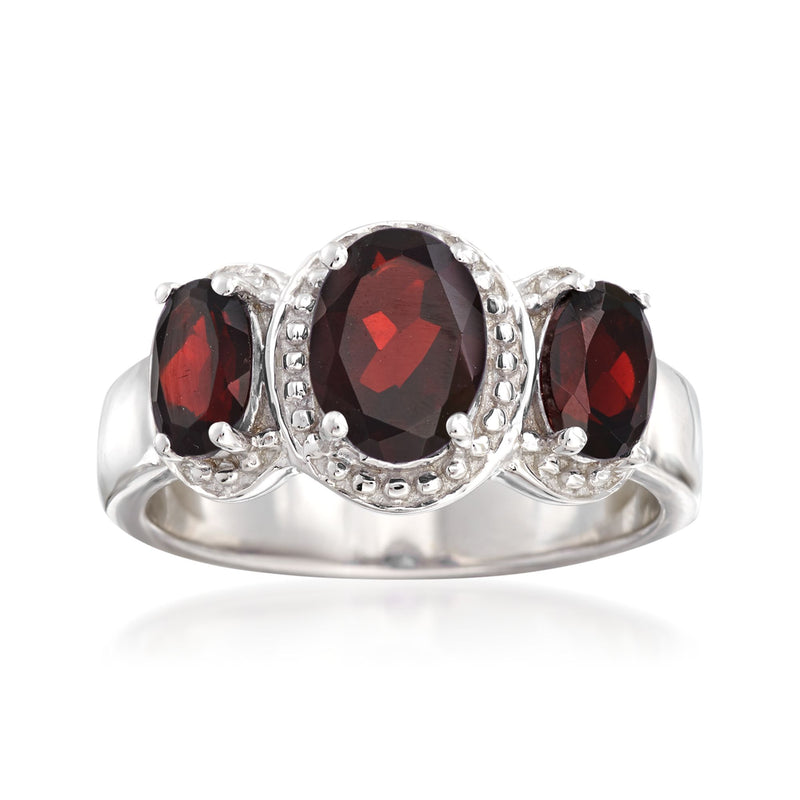 Sterling silver three-stone garnet ring with oval center and two round side stones