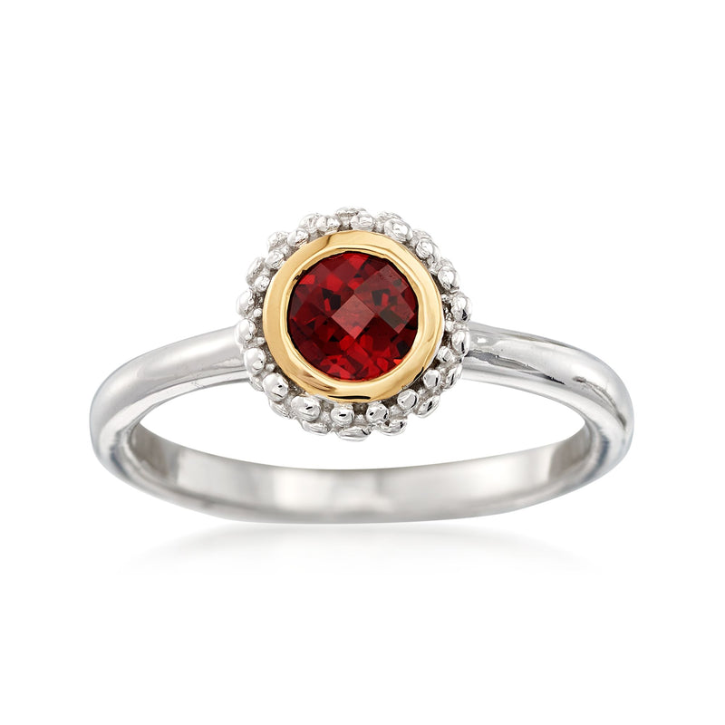 Garnet ring with round red gemstone in 18kt gold bezel, sterling silver halo