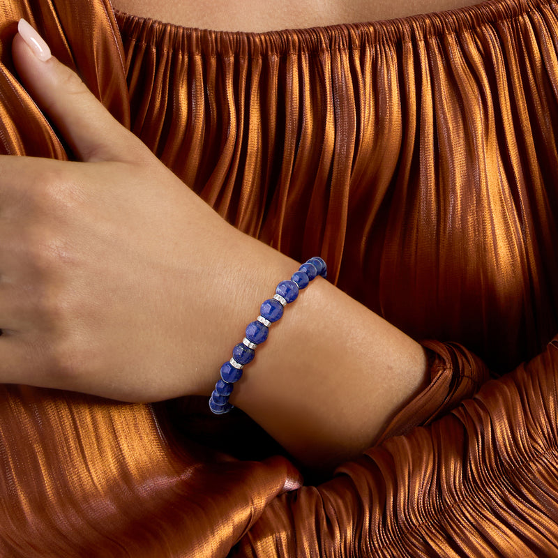 Lapis bead stretch bracelet on wrist with silver diamond-accent beads