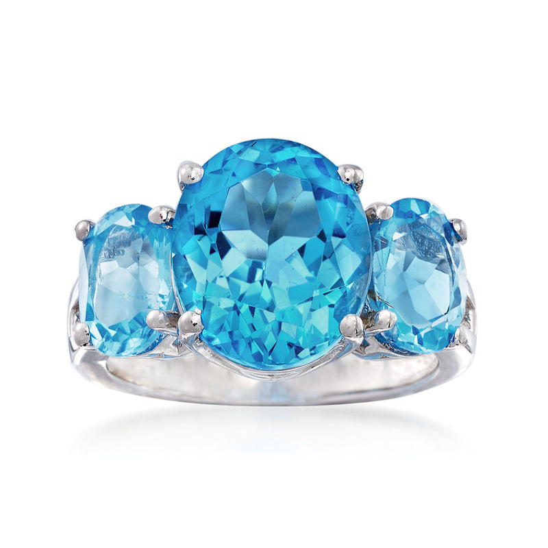 Sterling silver three-stone ring with oval blue topaz center and side stones