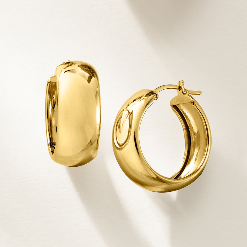 Thick wide gold hoop earrings, smooth polished surface with hinged back