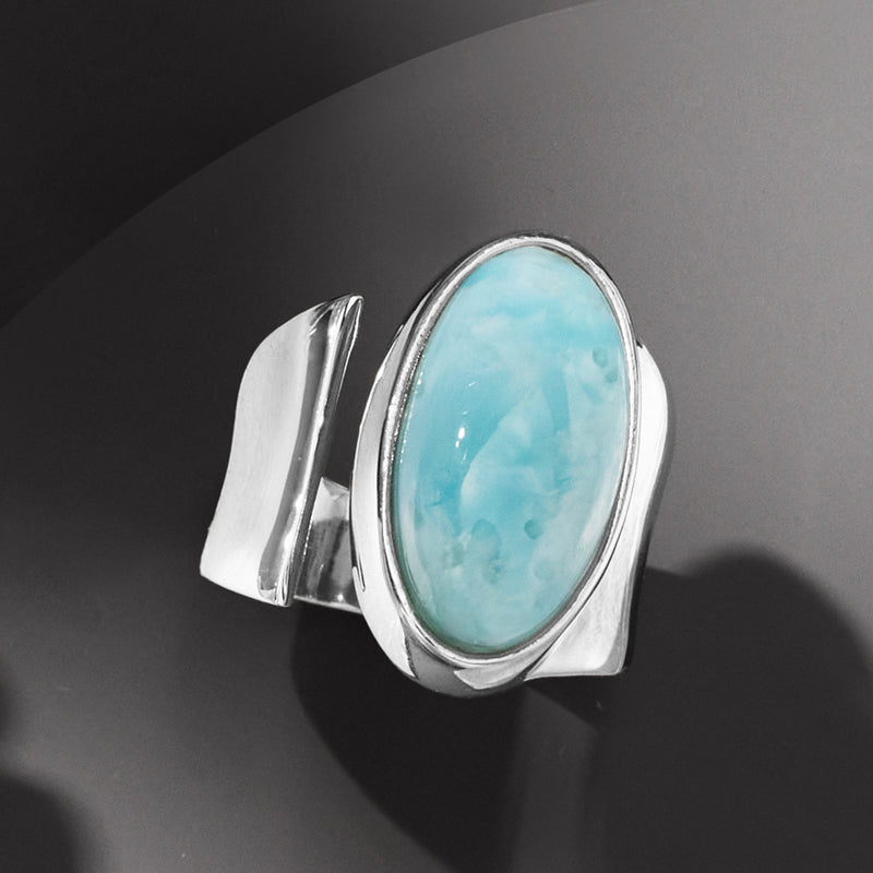Sterling silver wrap ring with blue-green oval larimar cabochon center bezel