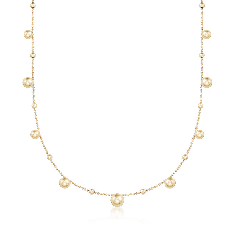 Gold-tone bead station necklace with round pearl-like beads on a fine chain
