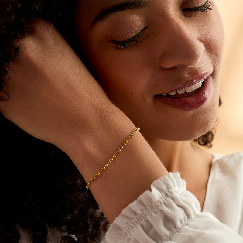 14kt yellow gold rolo-link bracelet on wrist, small round links