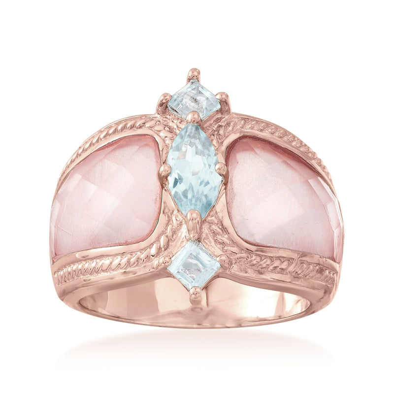 Rose gold ring with pink oval stones and light blue topaz center and side accents