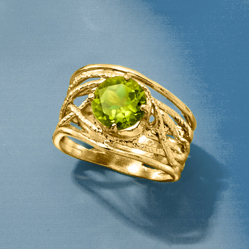Gold over sterling oval peridot-green gemstone ring with detailed textured band