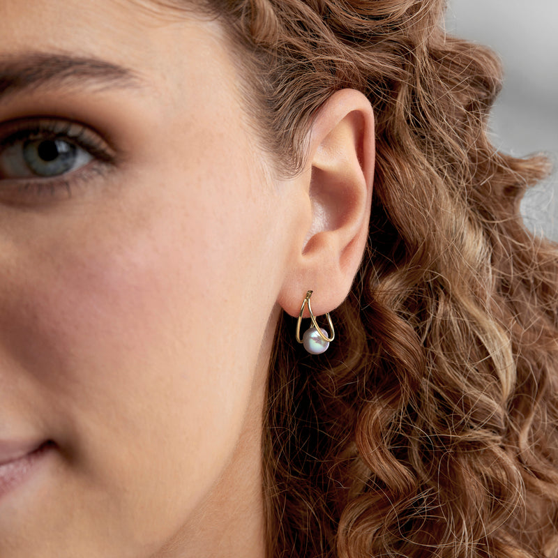 Gray cultured pearl double-hoop earrings in 14kt yellow gold on model ear