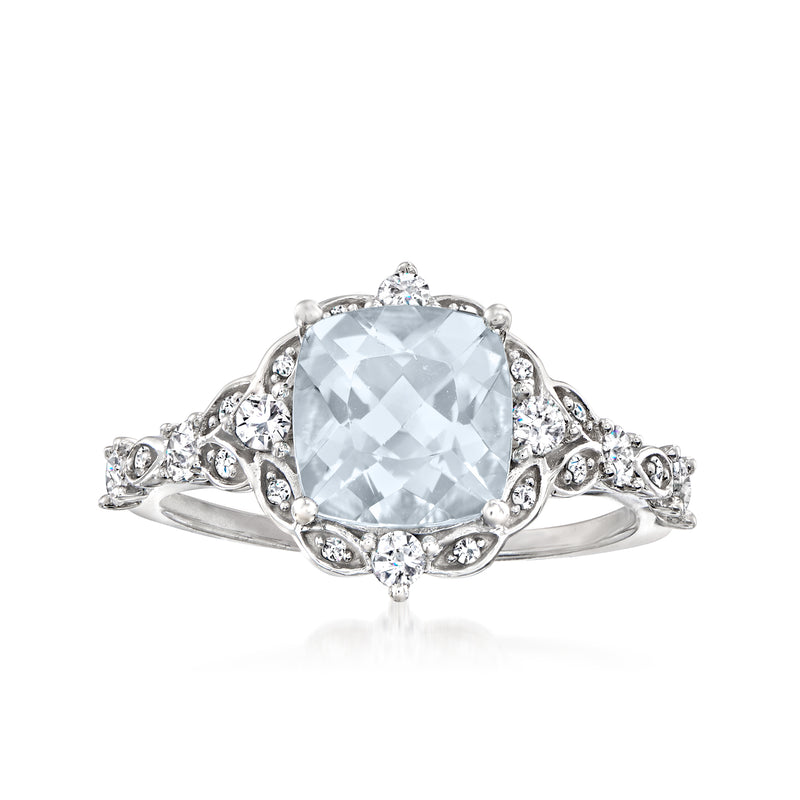 14kt white gold ring with cushion-cut aquamarine center, diamond halo and side stones