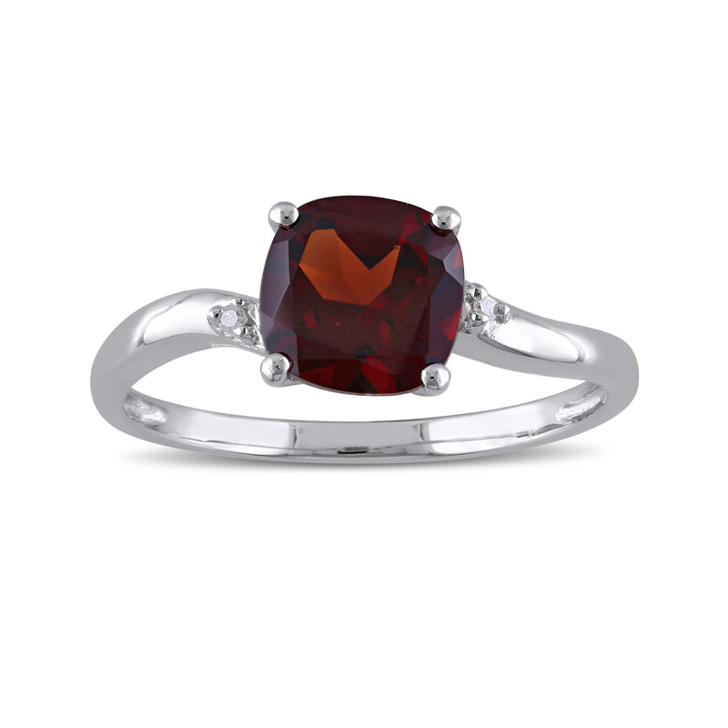 Sterling silver ring with oval garnet center and small diamond accents, prong set