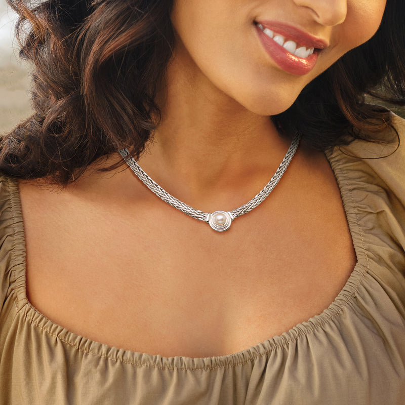 Wheat-chain cultured pearl necklace on model, round sterling pendant at collar