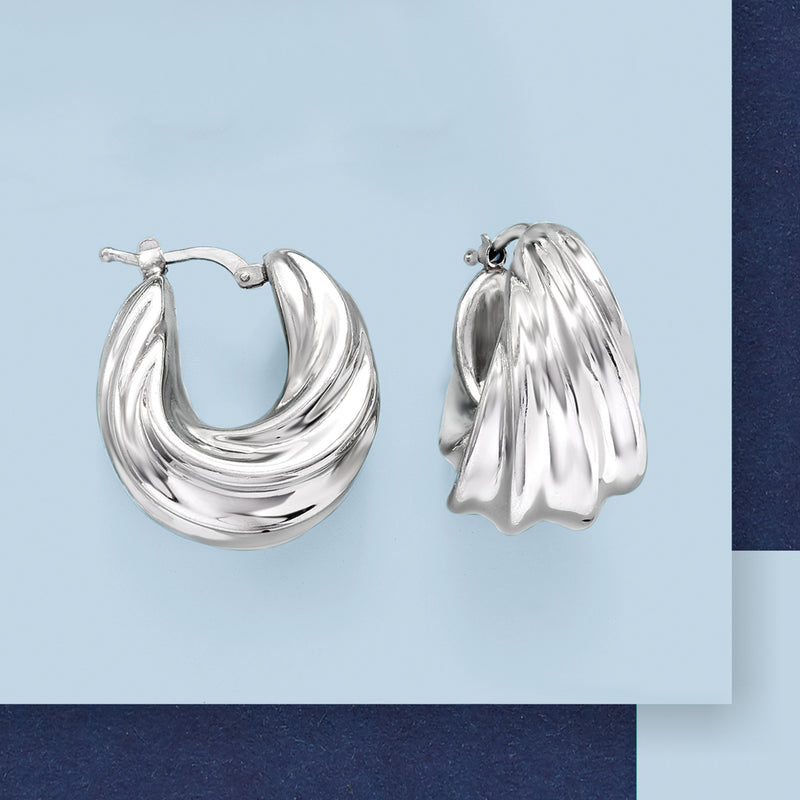 Twisted silver hoop earrings with concentric ridged texture and small clasp