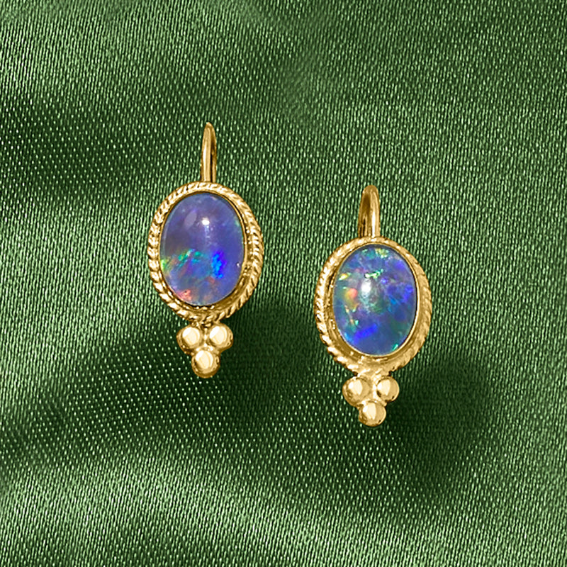 Gold leverback oval earrings with multicolor iridescent blue opal-like center and bead drops