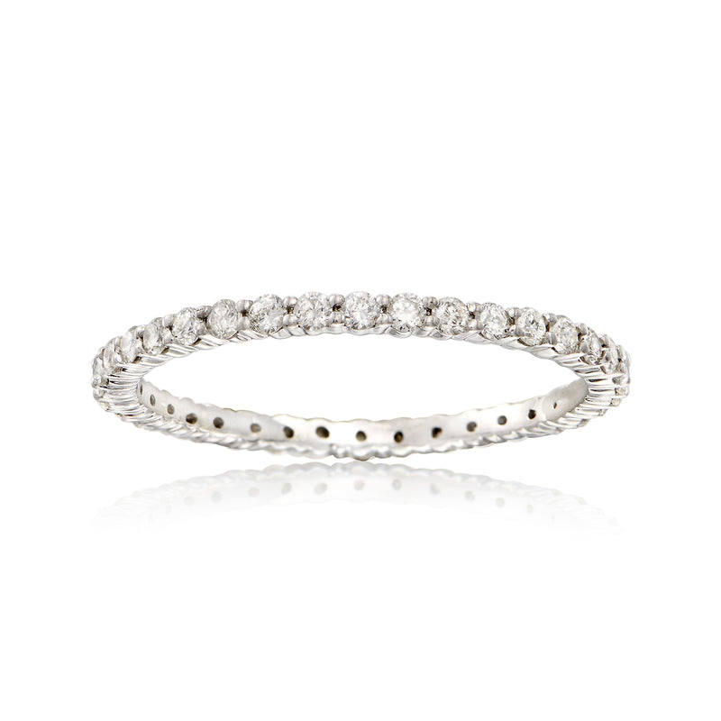 Sterling silver diamond eternity band with small round stones on a slim raised row