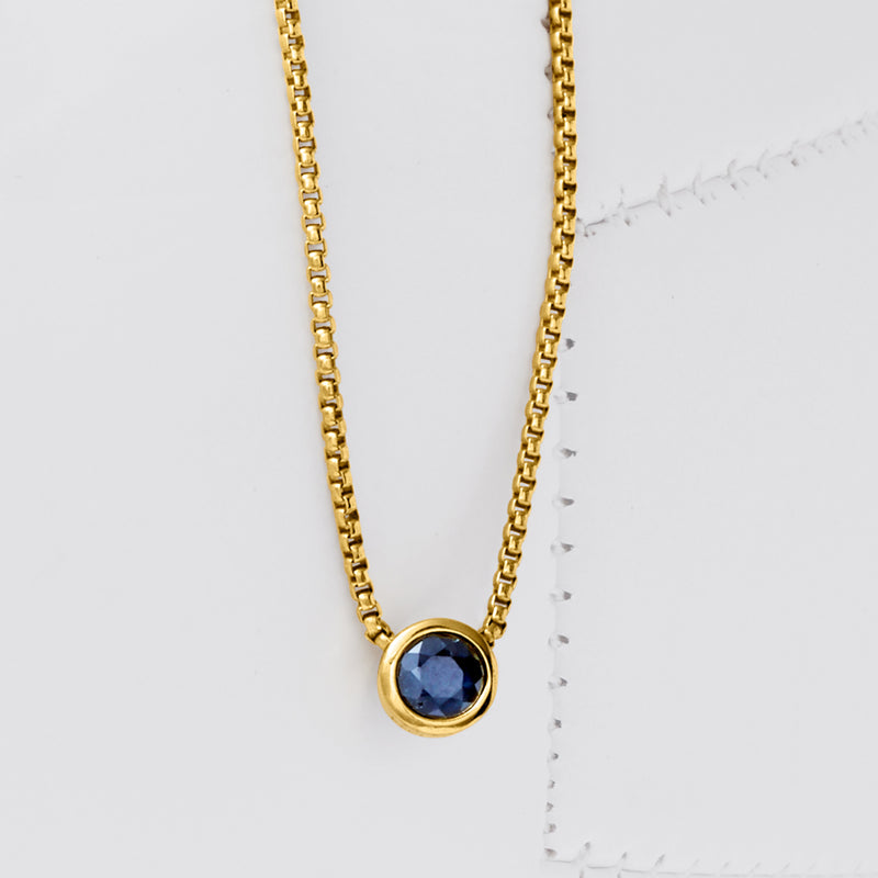 Gold over sterling necklace with round dark-blue bezel pendant on link chain
